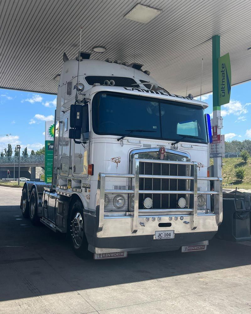 A White Heavy Truck Parked in Fuel Station — Joe Camilleri Transport in Fyshwick, ACT