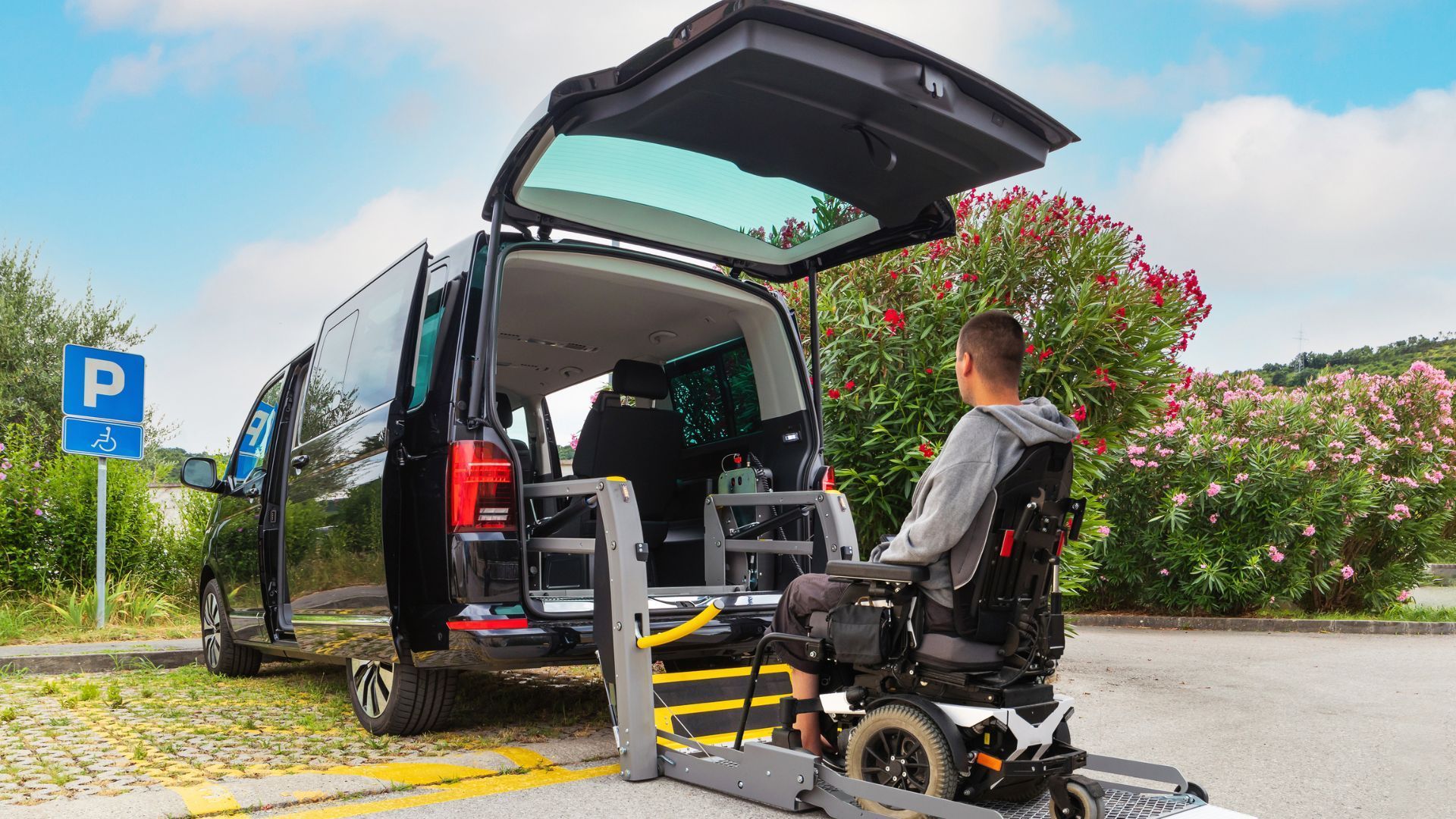 A man in a wheelchair is getting out of a van