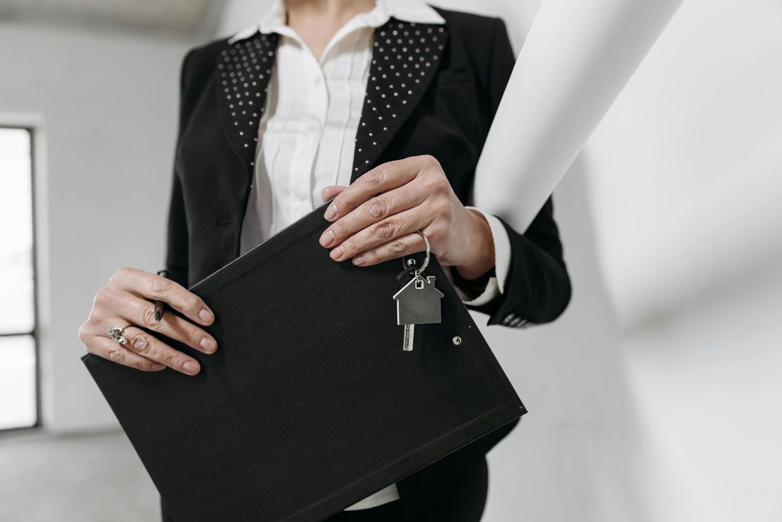 Close-up of keys exchanged by a licensed real estate settlement agent managing an escrow account closing.