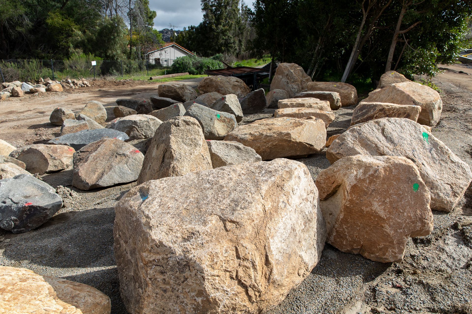 A pile of rocks with one that has a green sticker on it