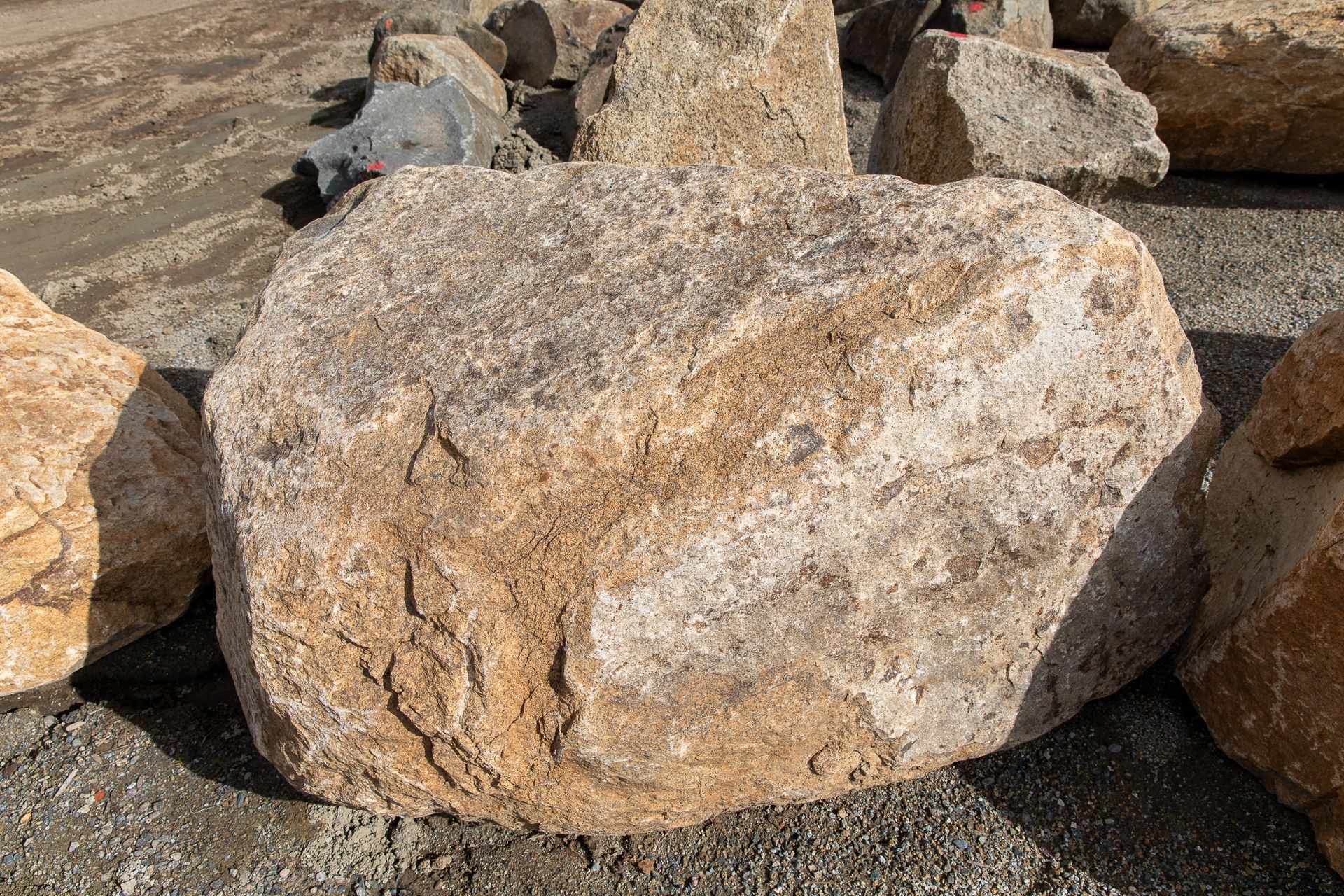 A large rock is sitting on a pile of gravel