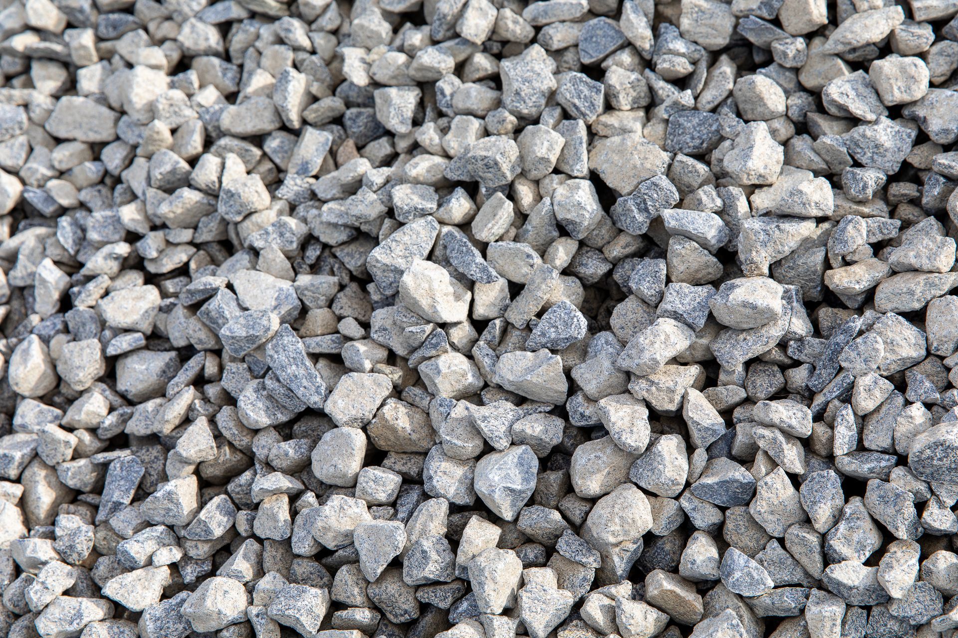 A pile of gravel is sitting on the ground.
