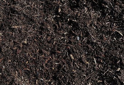 A pile of dirt with a lot of small pieces of wood in it
