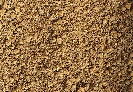 A close up of a pile of dirt with a lot of small stones.