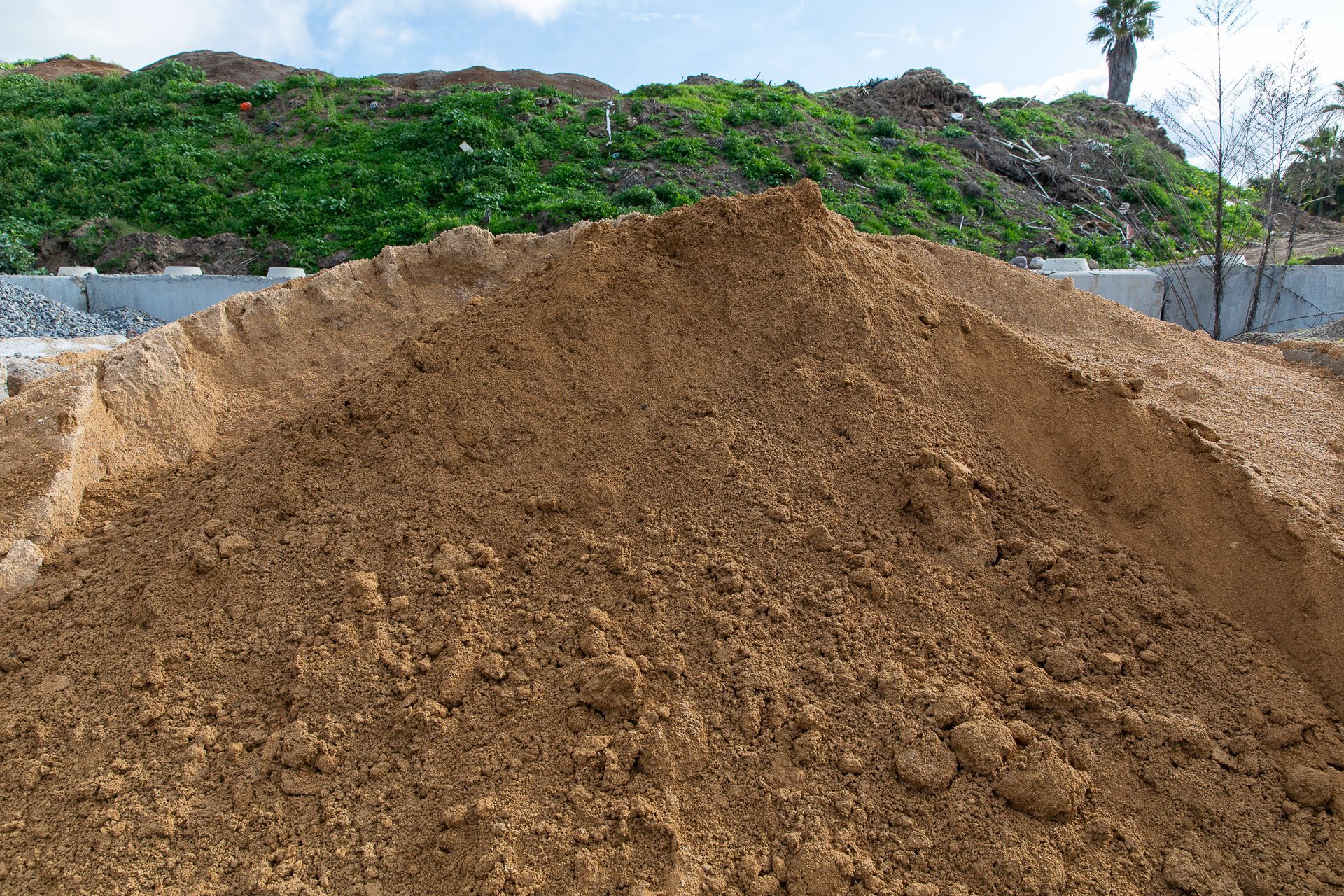 A pile of dirt is sitting on top of a hill