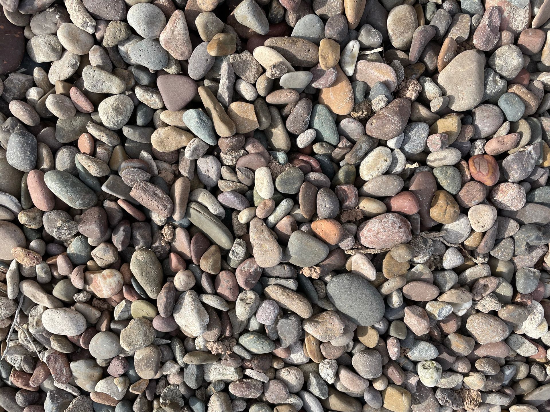 A pile of rocks sitting on top of each other on the ground.