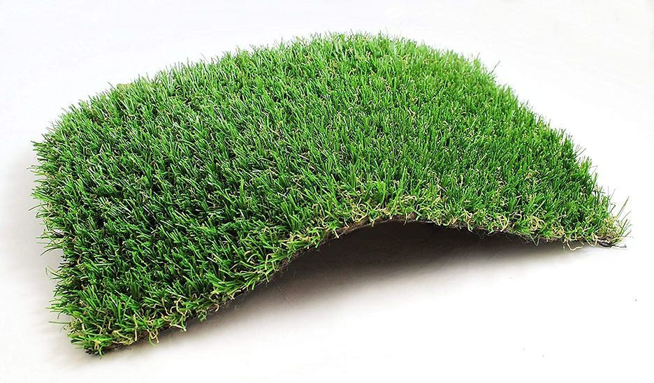 A piece of green grass on a white surface