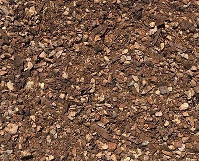 A pile of brown gravel is sitting on the ground.