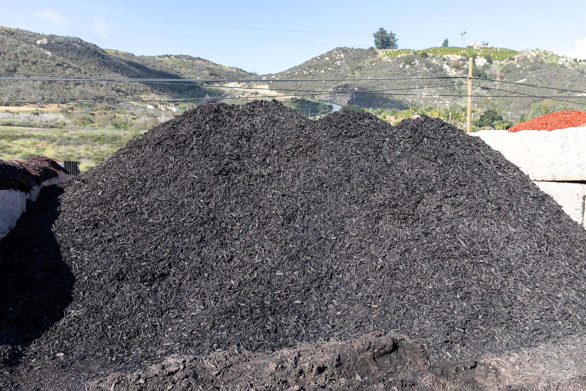 A pile of coal is sitting in front of a mountain