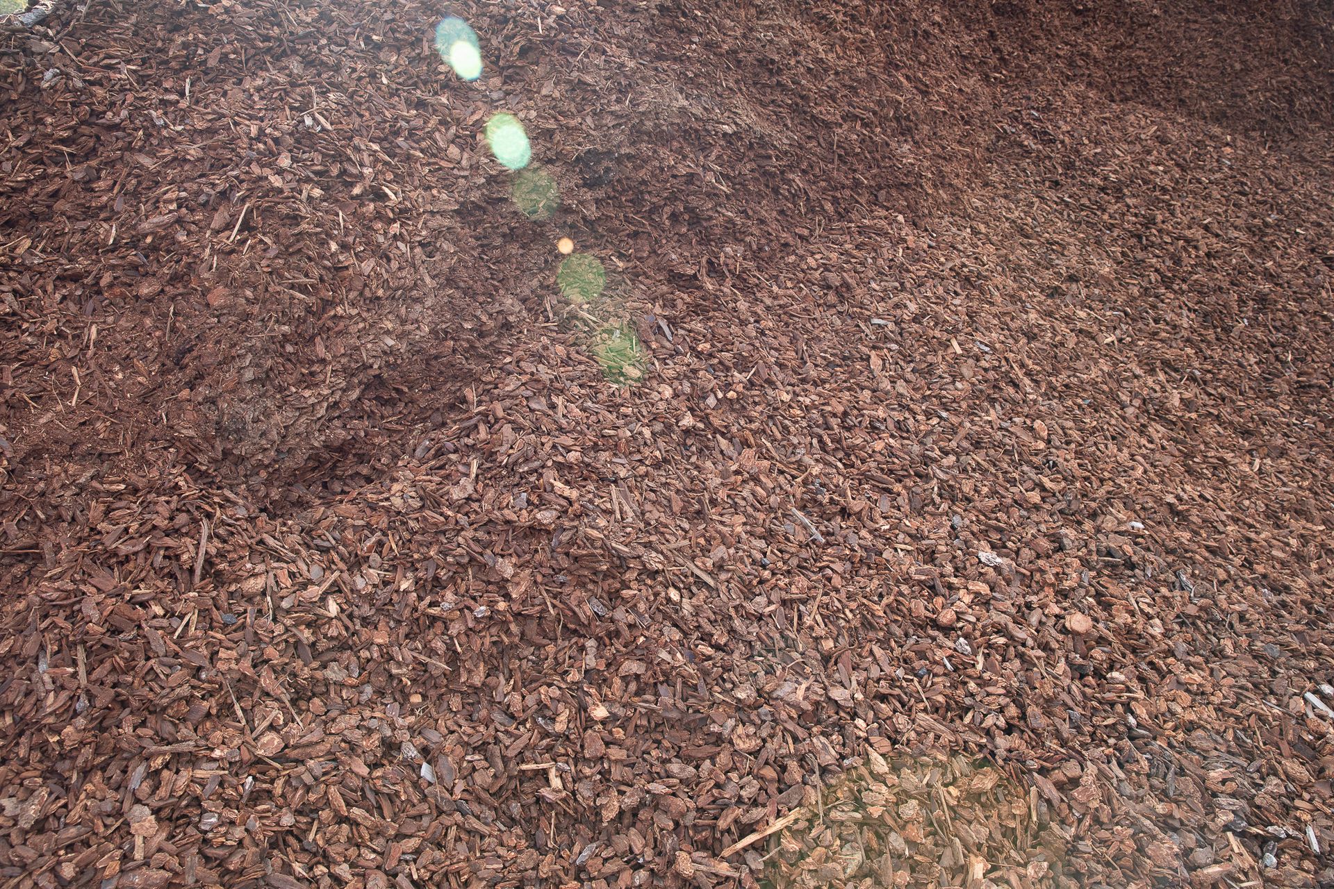 A pile of brown gravel with the sun shining through it