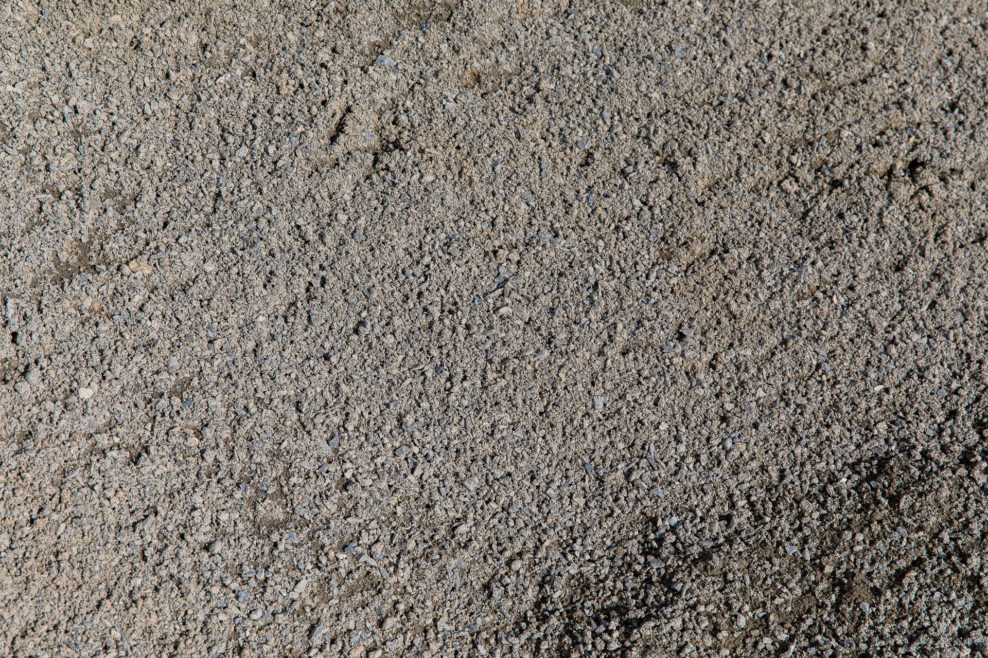 A close up of a pile of sand with a grainy texture.