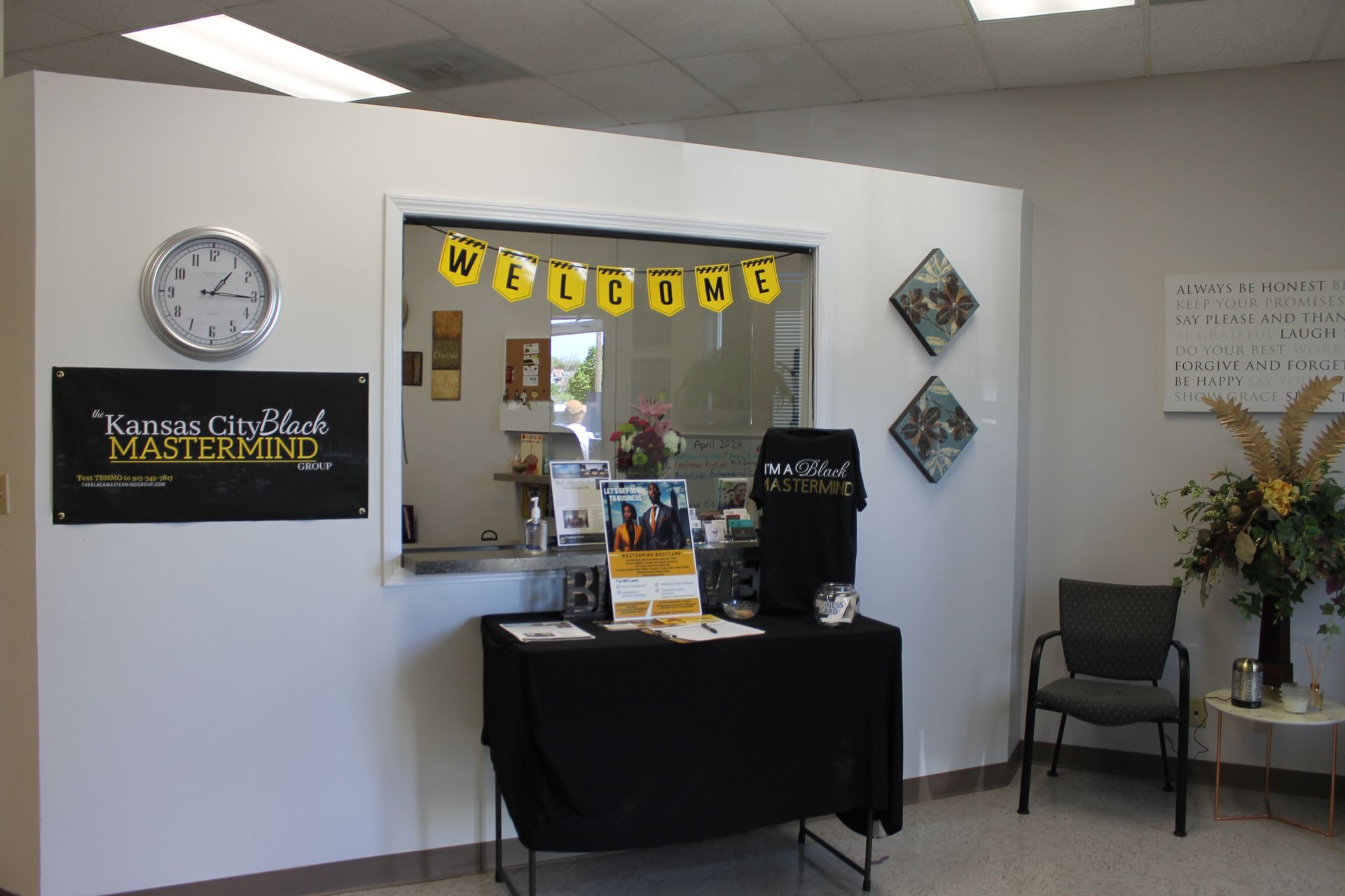 A welcome sign hangs above a table in a room