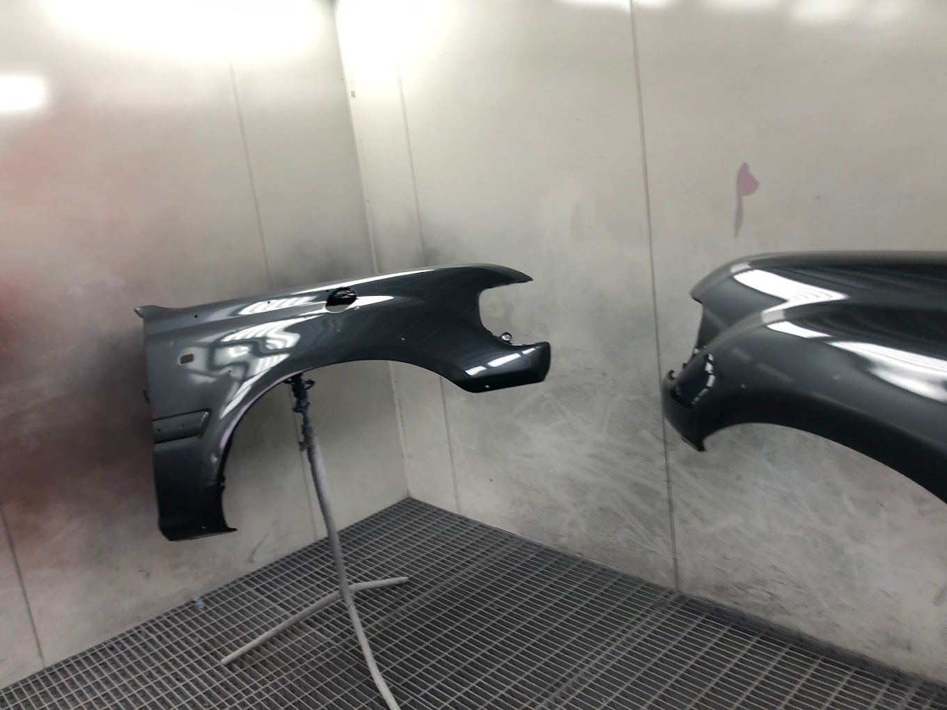 A Car Parts Are Being Painted in A Paint Booth — East Maitland Body Repairs in East Maitland, NSW