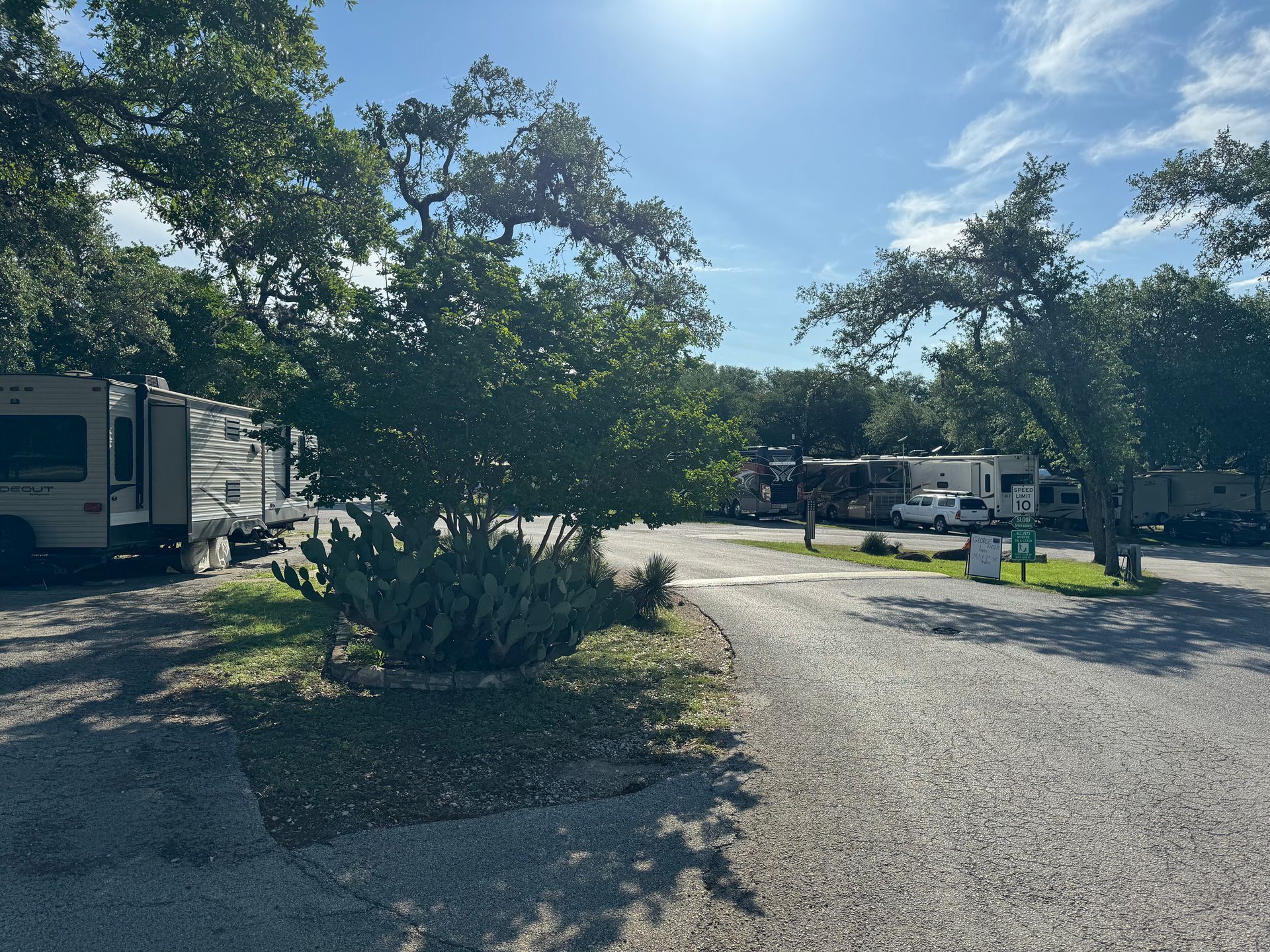 A lot of rv 's are parked on a gravel road