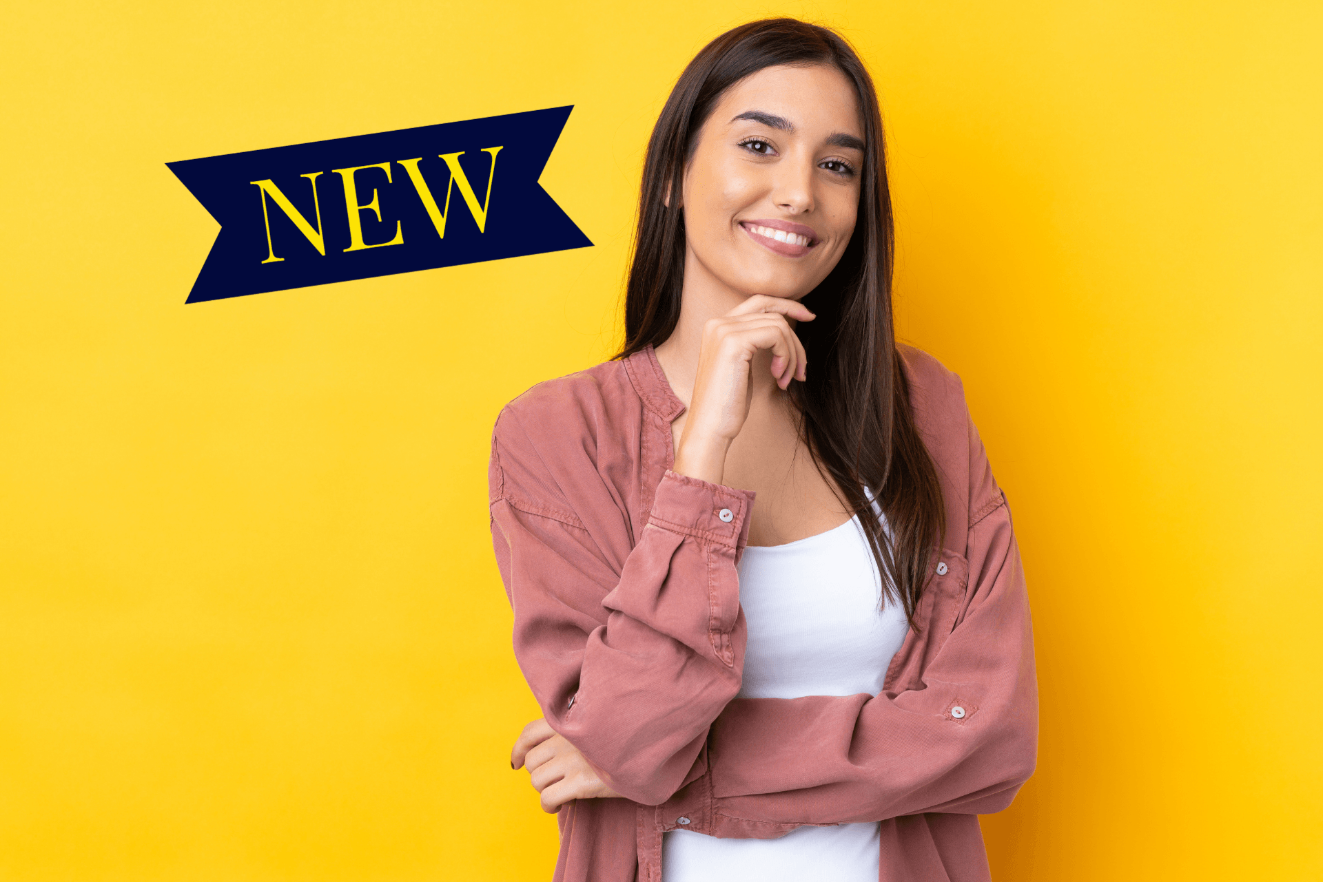A woman is standing in front of a yellow background and smiling.