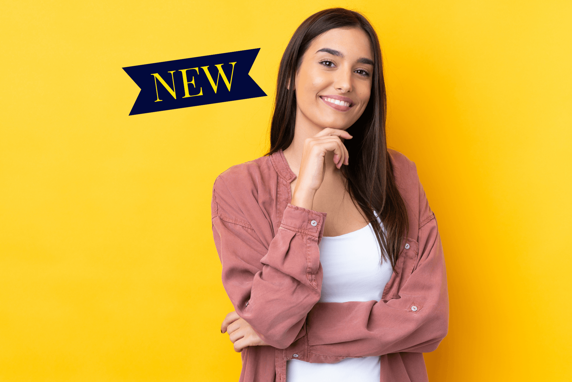 A woman is standing in front of a yellow background and smiling.