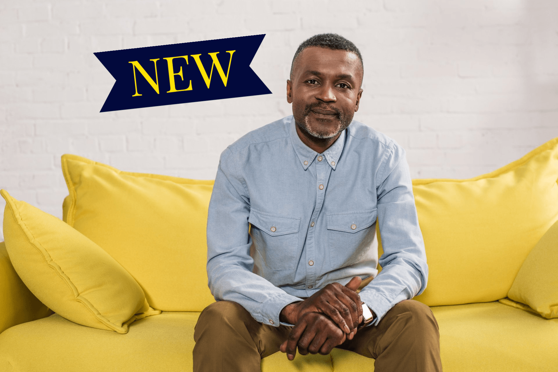 Man sitting on yellow sofa
