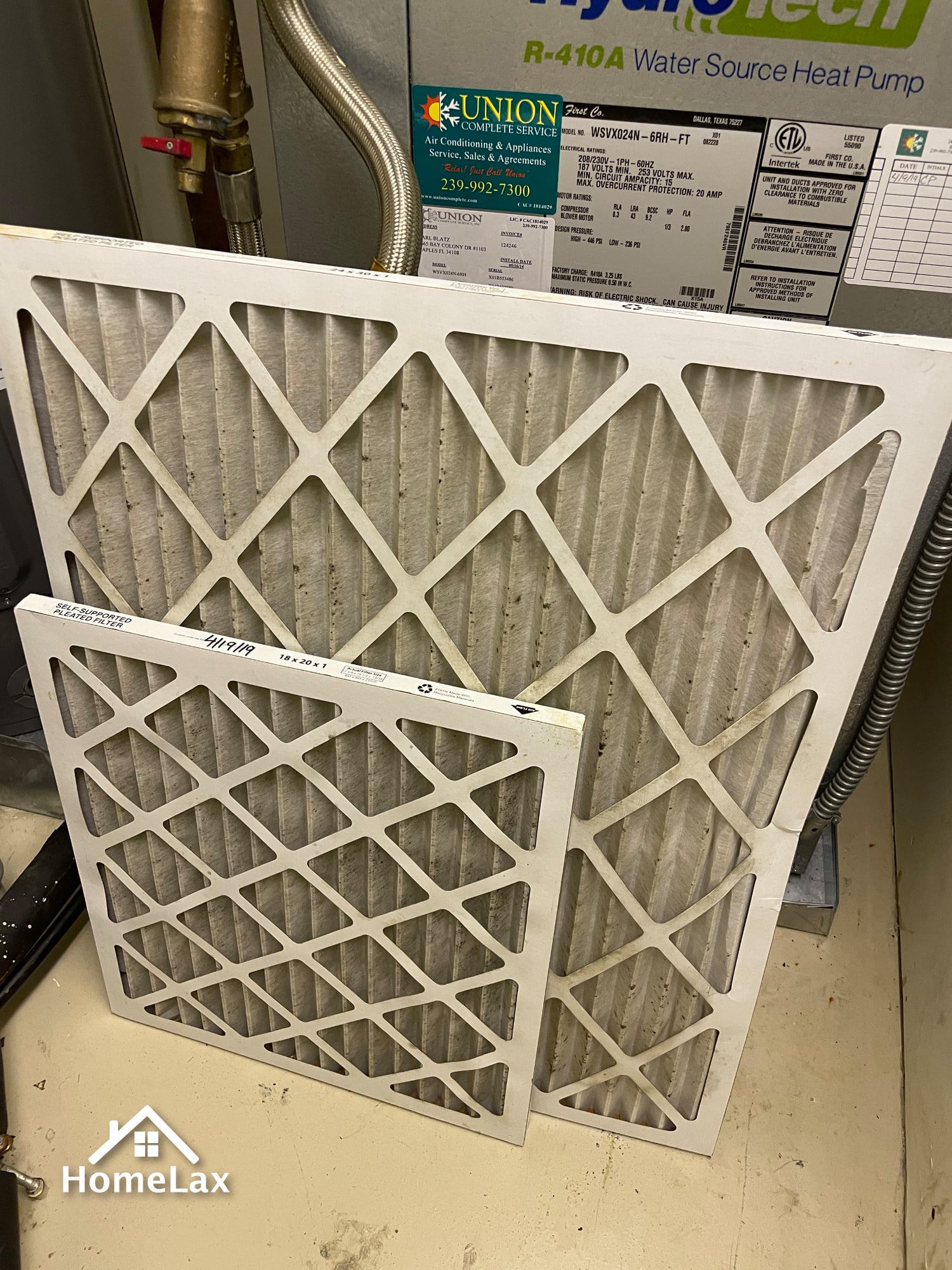 A couple of filters sitting on top of each other on a floor.