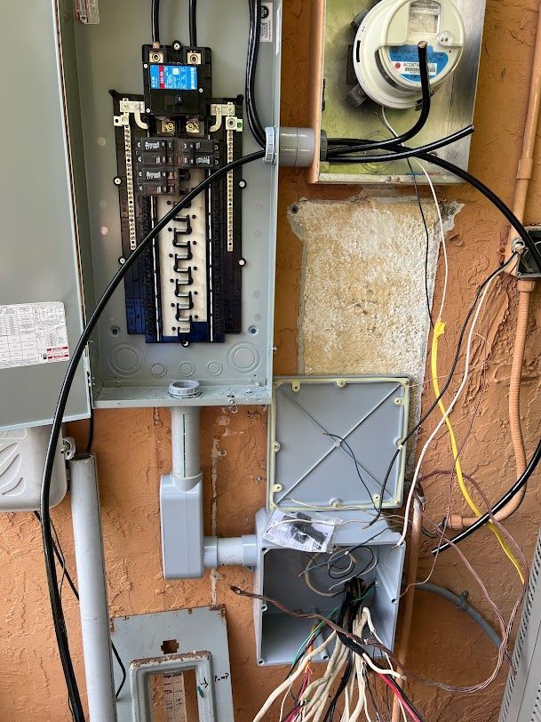 a bunch of wires are connected to a electrical box on a wall