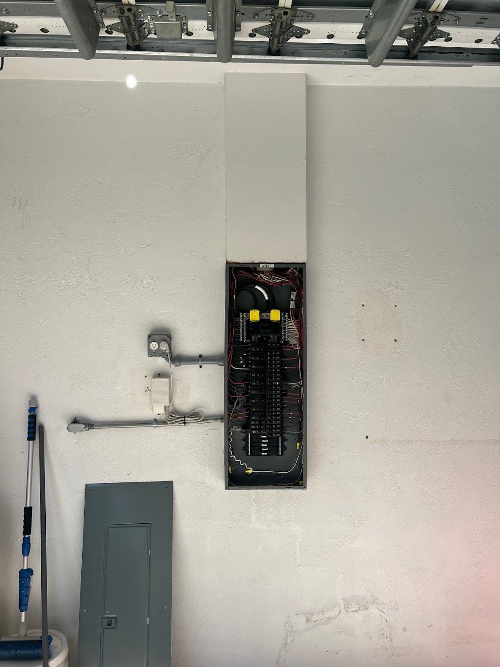 an electrical box is hanging on a white wall in a room
