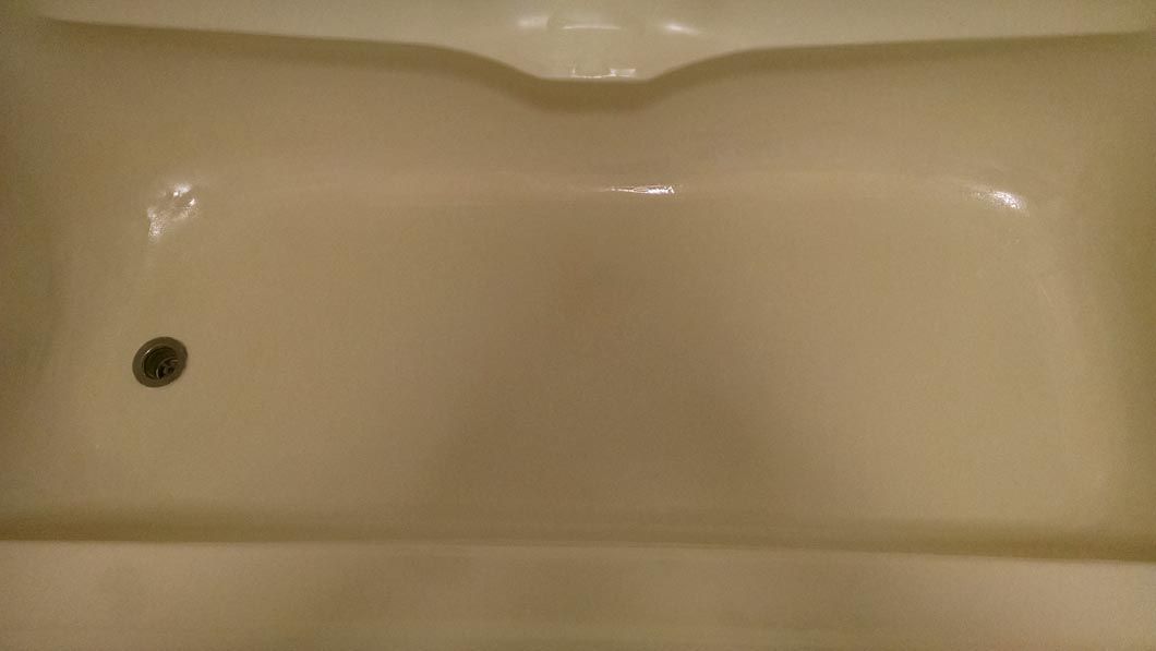 a white bathtub with a hole in the middle of it .