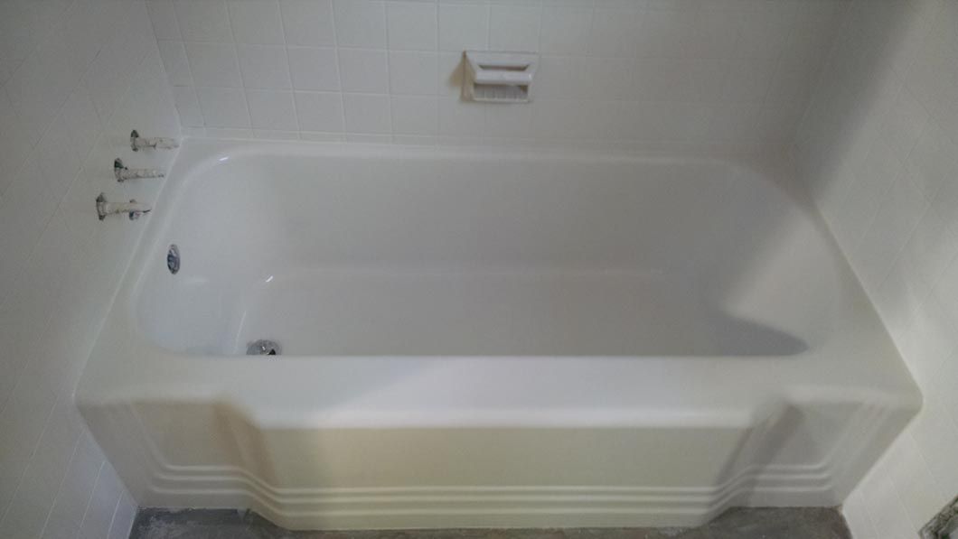 a white bathtub is sitting in a bathroom next to a white wall .