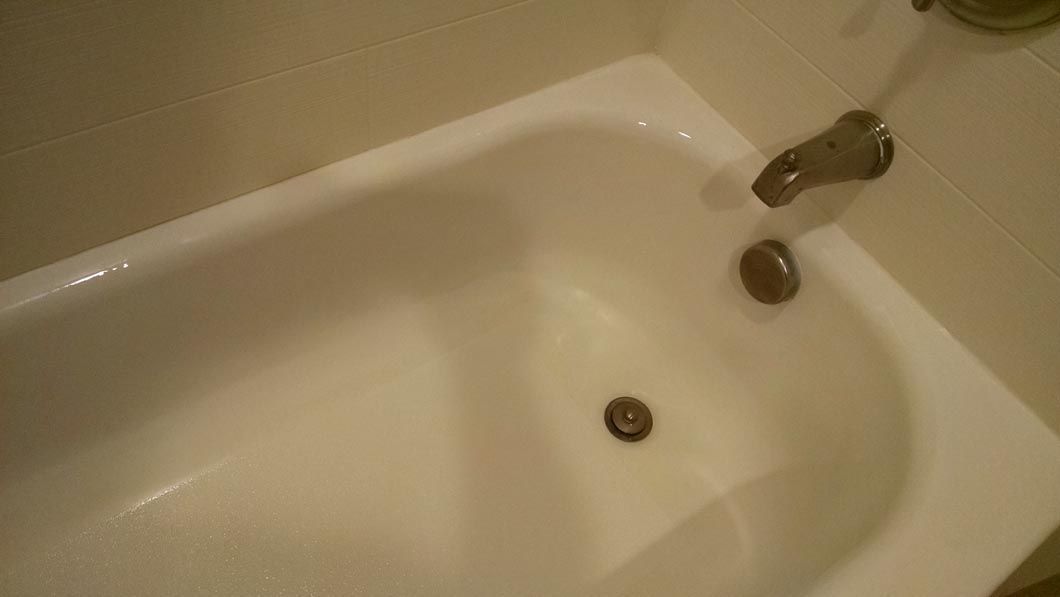 a white bathtub with a faucet in a bathroom .