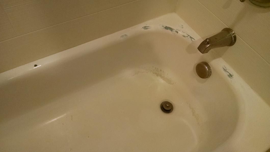 a white bathtub with a faucet on it in a bathroom .