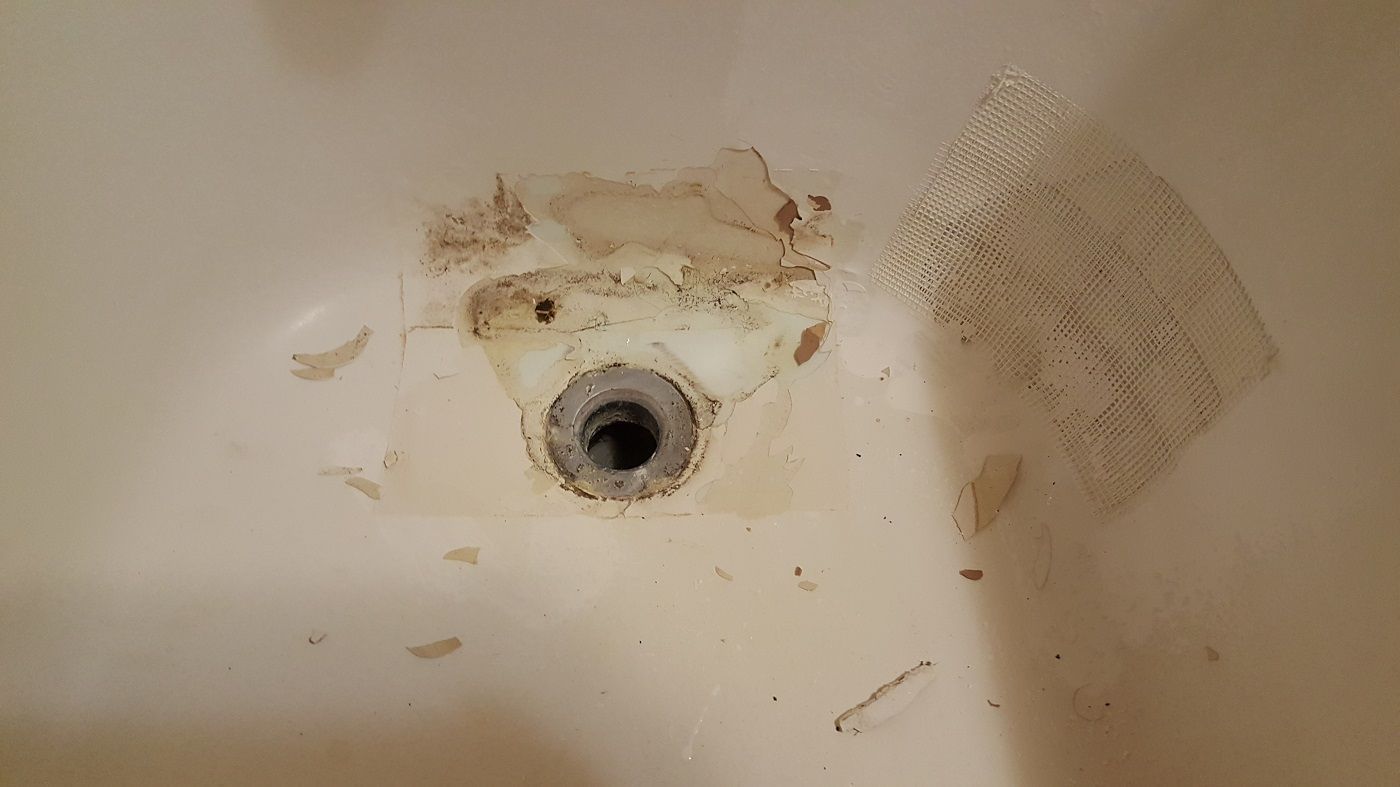 a close up of a dirty sink with a hole in it .