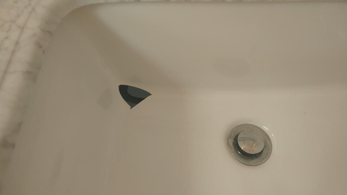 a close up of a bathtub with a drain in it .