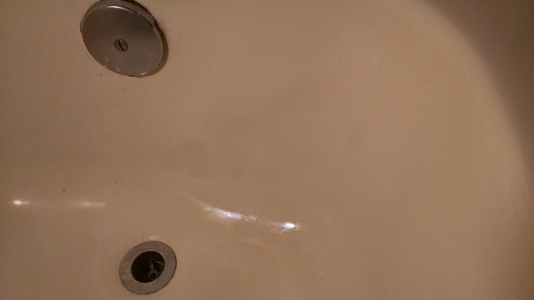 a close up of a bathtub with a drain in it .