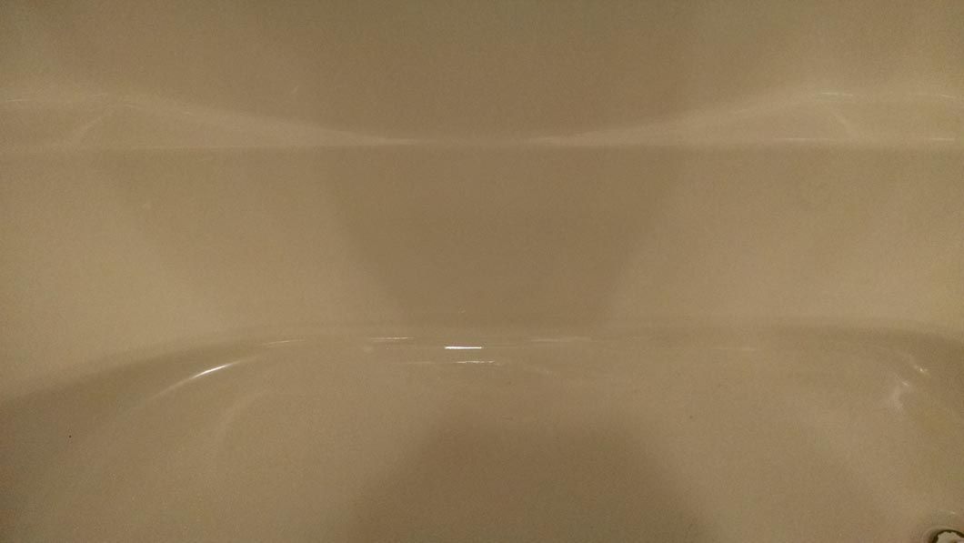 a close up of a white bathtub in a bathroom .