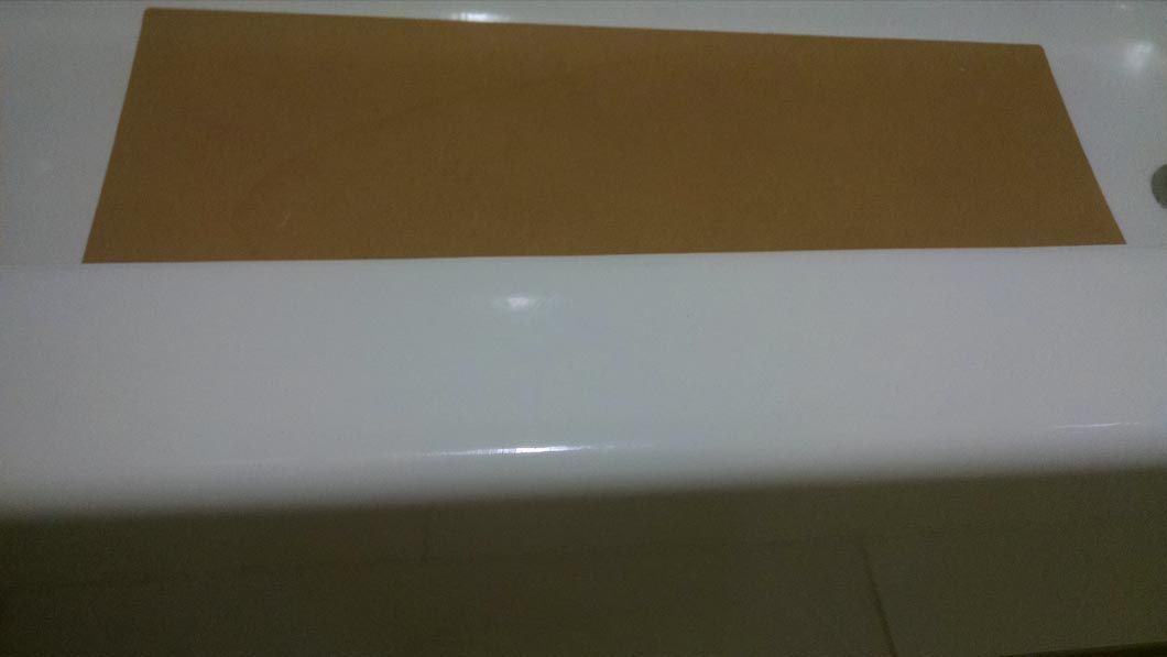 a piece of brown paper is sitting on top of a white counter .
