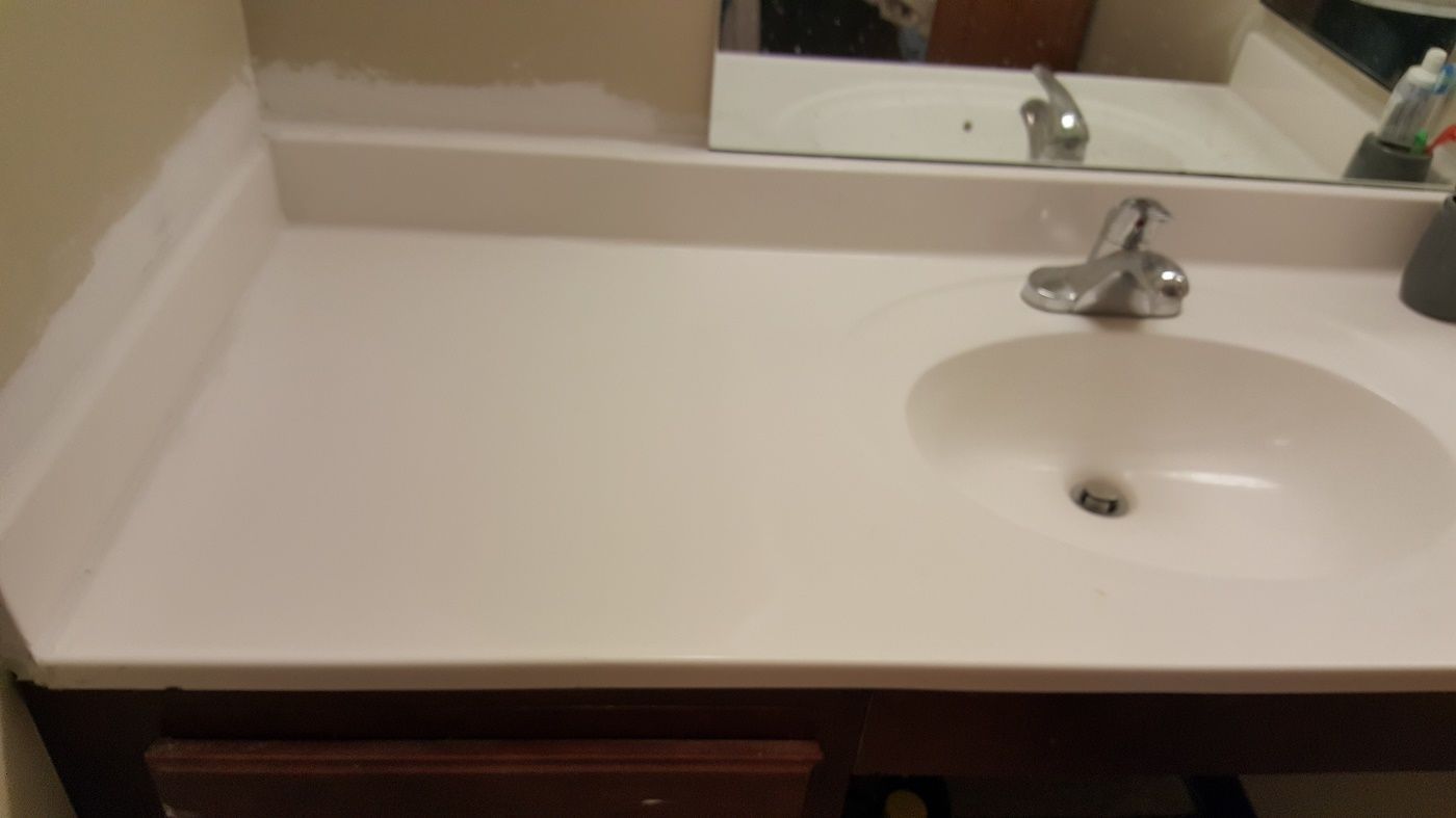 a bathroom sink with a faucet and a mirror .