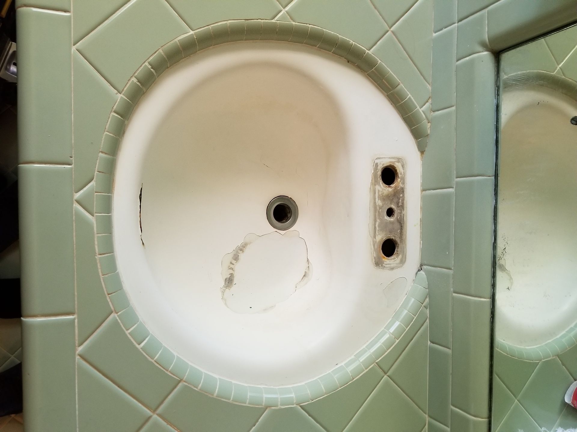 a bathroom sink with a hole in the wall .