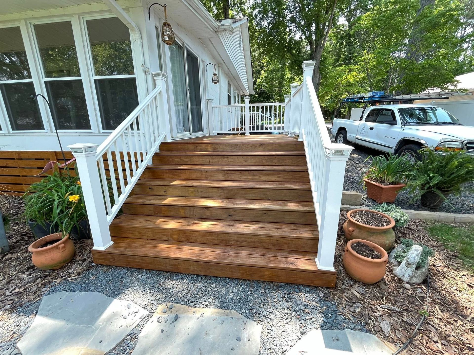 Man in overalls uses a screwdriver on a kitchen cabinet. A toolbox sits open nearby.