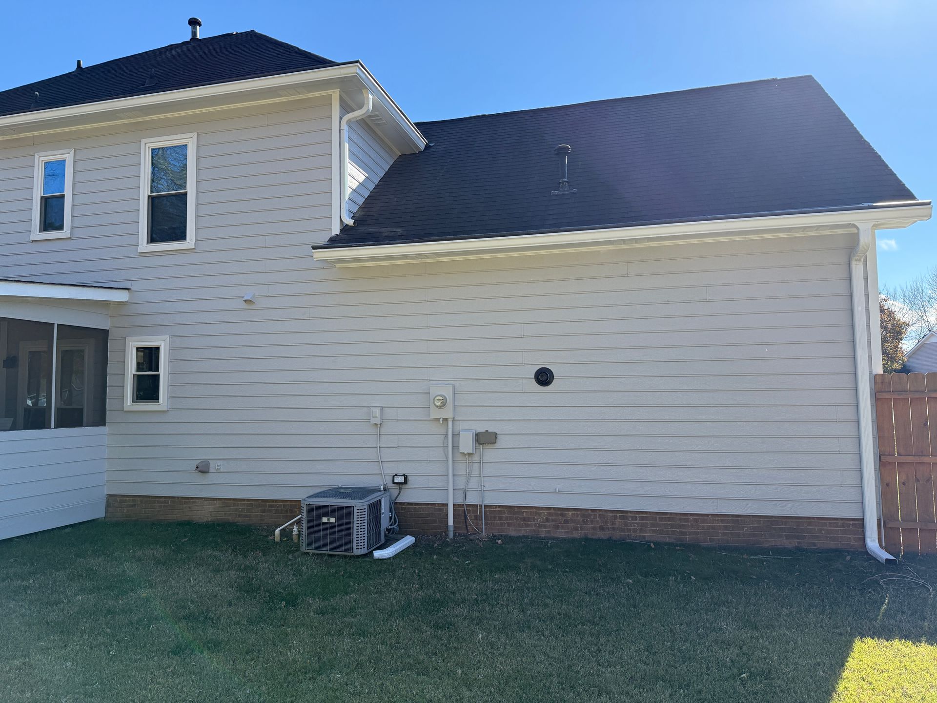 Wooden staircase with white risers and brown treads, wooden handrail, leading upward.