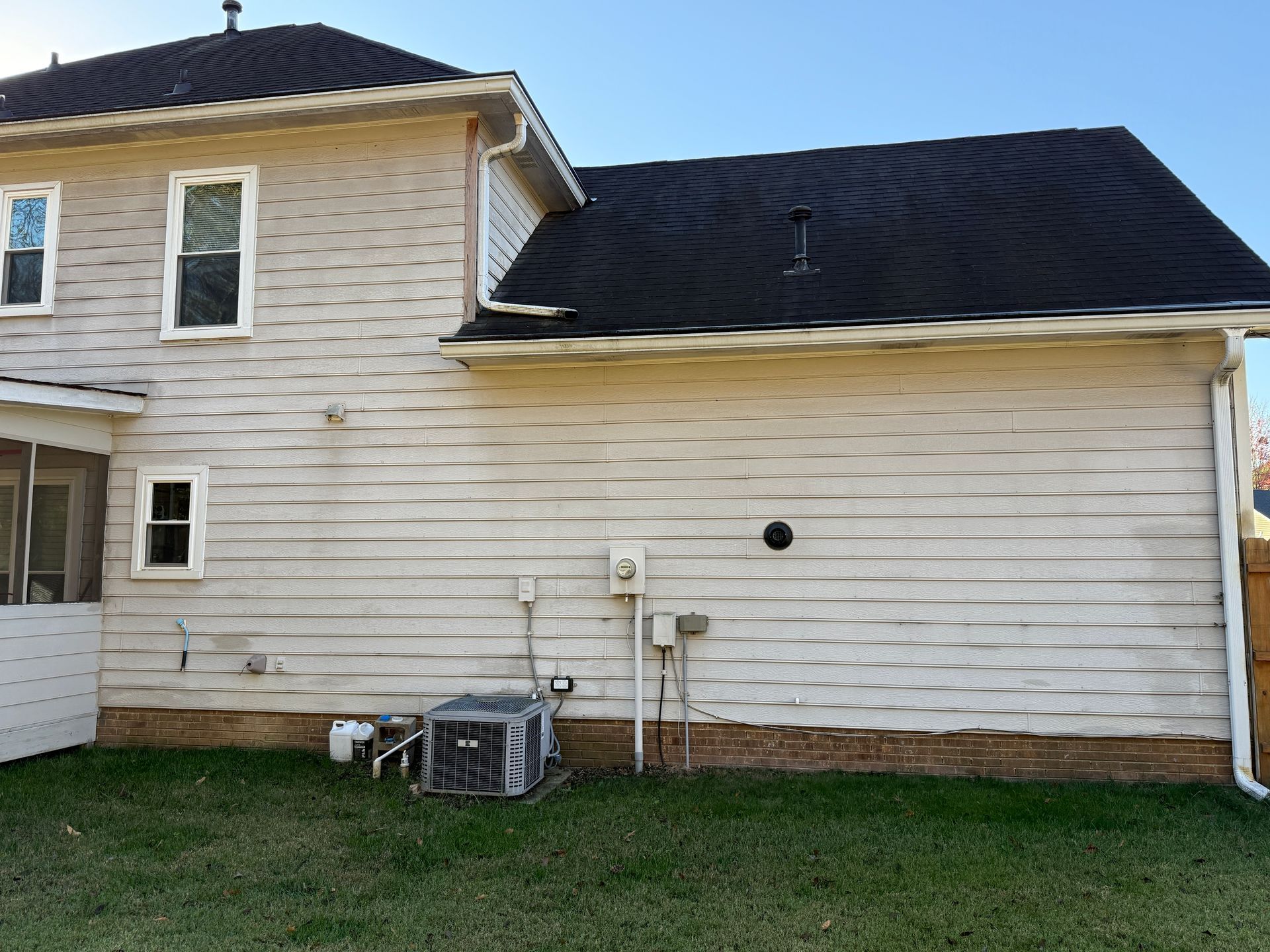 Wooden staircase with white banisters and a baby gate.