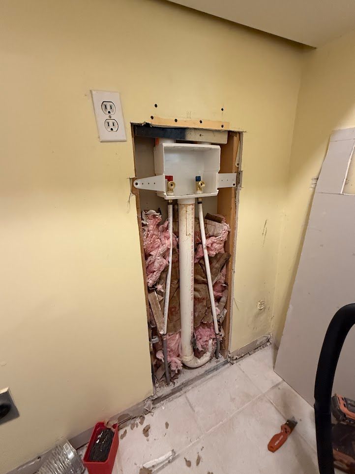 Bathroom with sink, mirror, and light fixture. Cream-colored walls, white vanity, and silver fixtures.