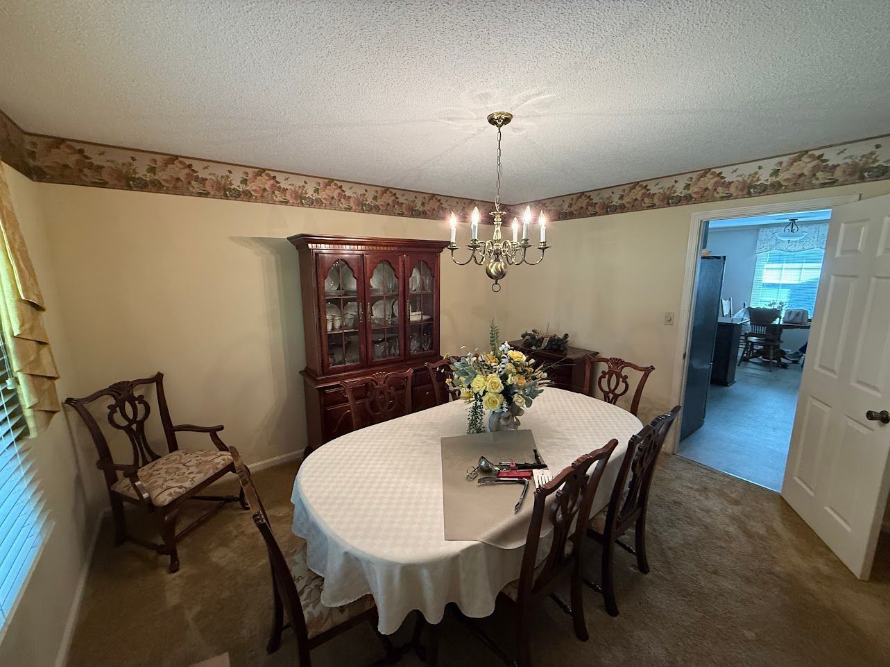 Wooden staircase with white banisters and a baby gate.