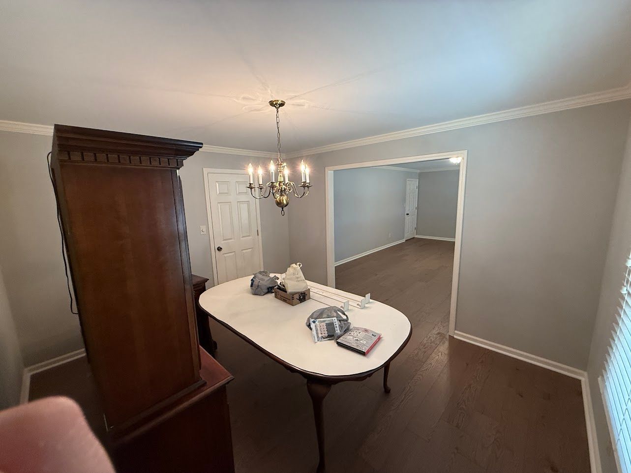 Bathroom with a vanity, mirror, and light fixture; light blue walls.