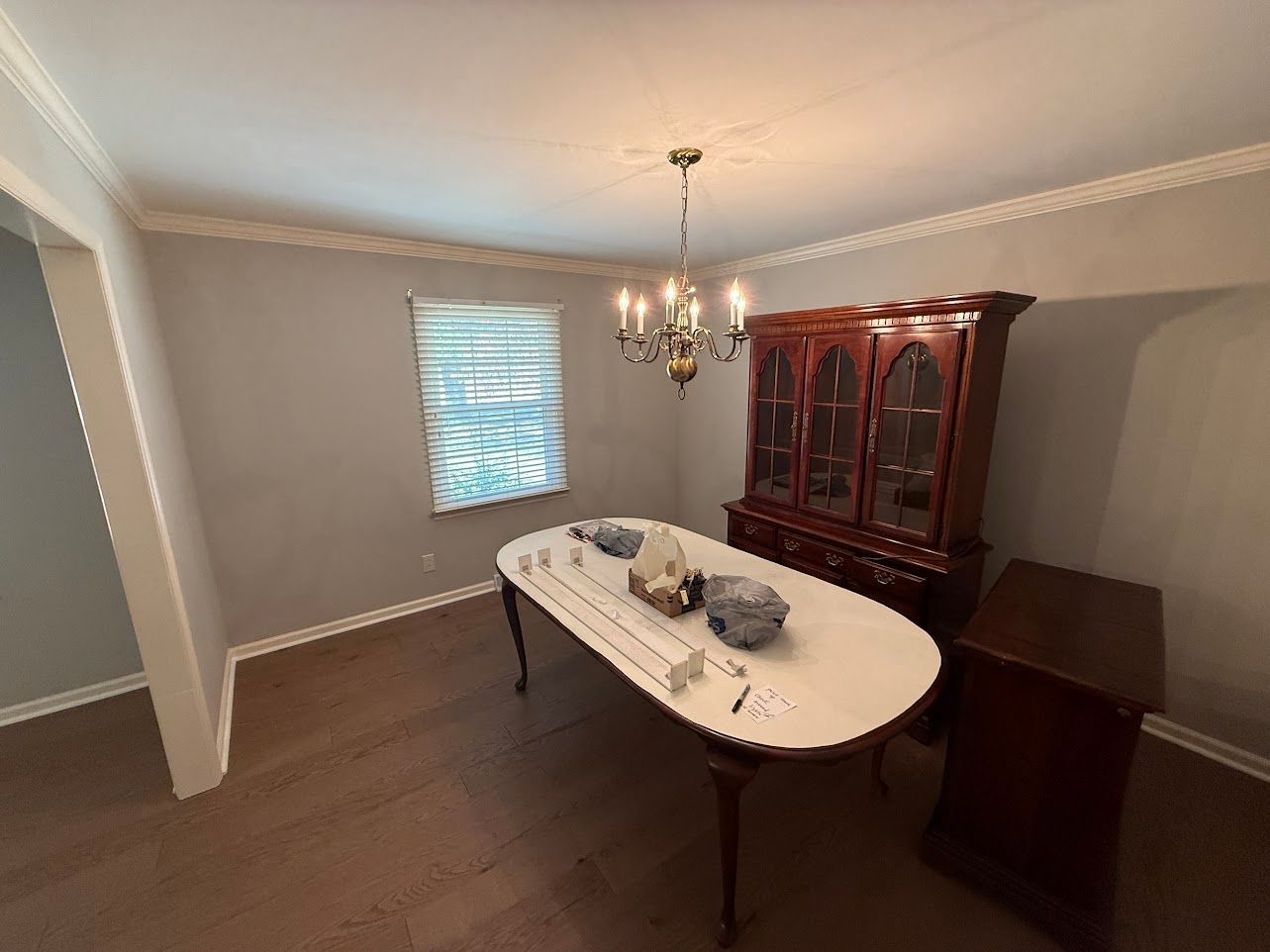Wooden staircase with white risers and brown treads, wooden handrail, leading upward.
