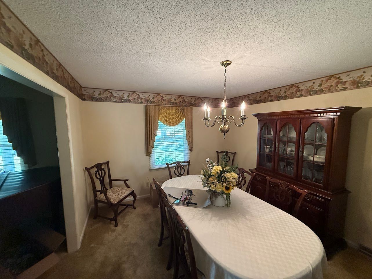 Wooden staircase with white banisters and a baby gate.