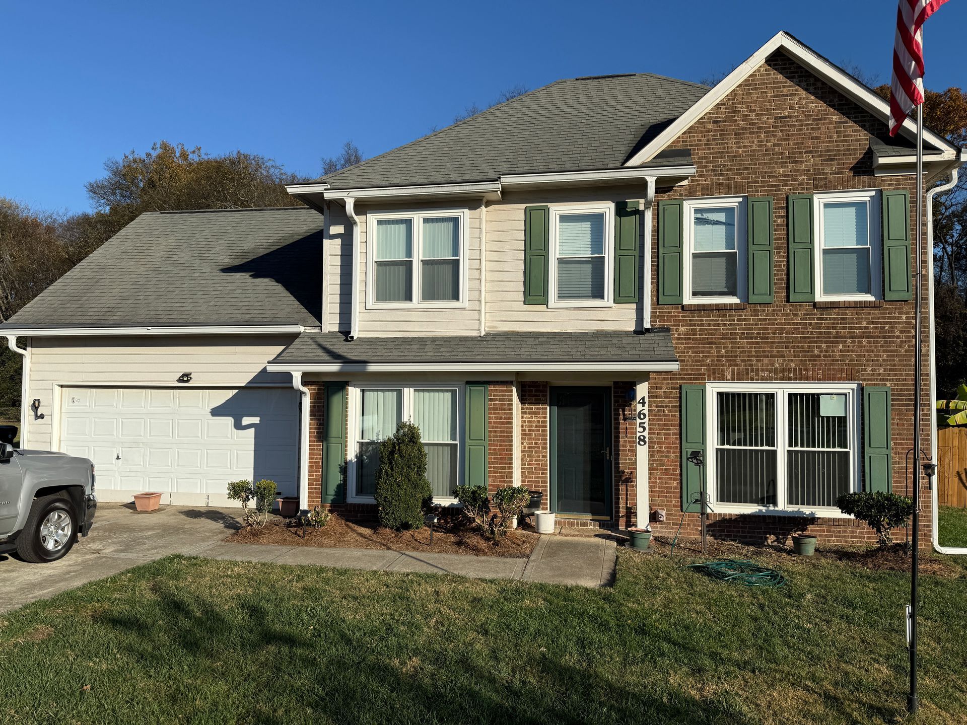 Ceiling with patched drywall and air vent; tan wall, doorway below.