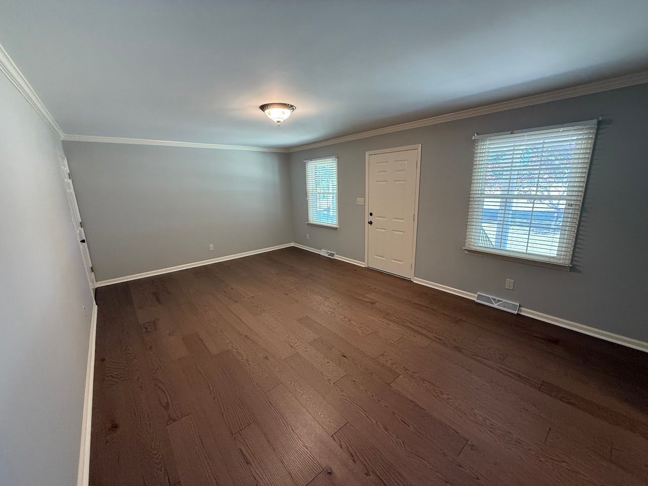 Bathroom with a vanity, mirror, and light fixture; light blue walls.