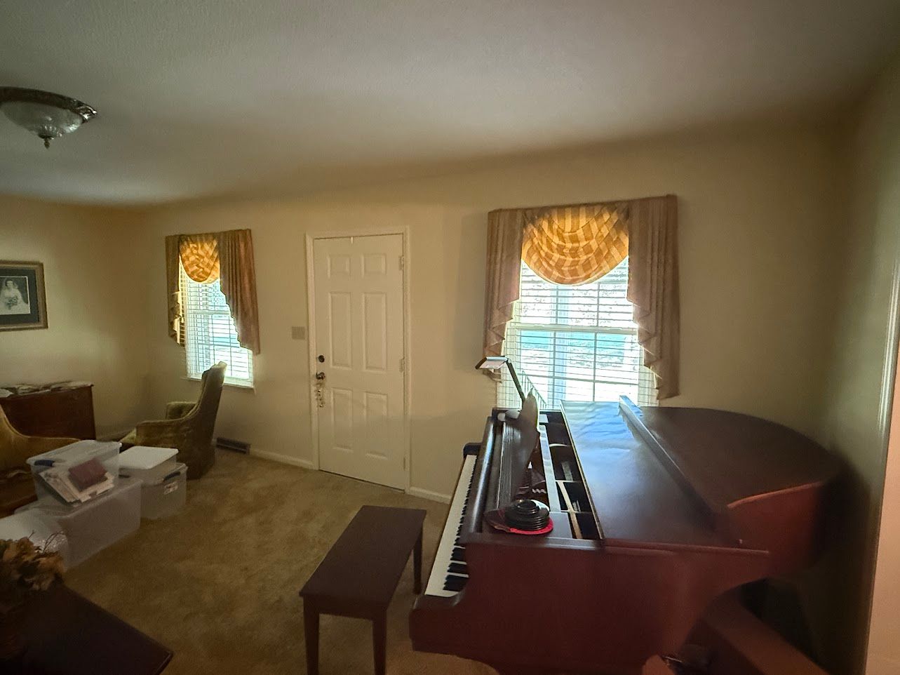 Bathroom with sink, mirror, and light fixture. Cream-colored walls, white vanity, and silver fixtures.