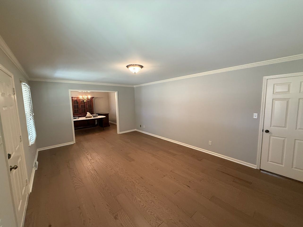 Bathroom with a vanity, mirror, and light fixture; light blue walls.