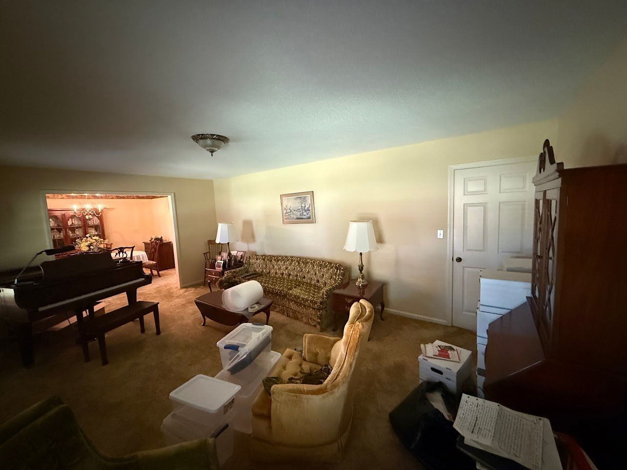 Bathroom with sink, mirror, and light fixture. Cream-colored walls, white vanity, and silver fixtures.