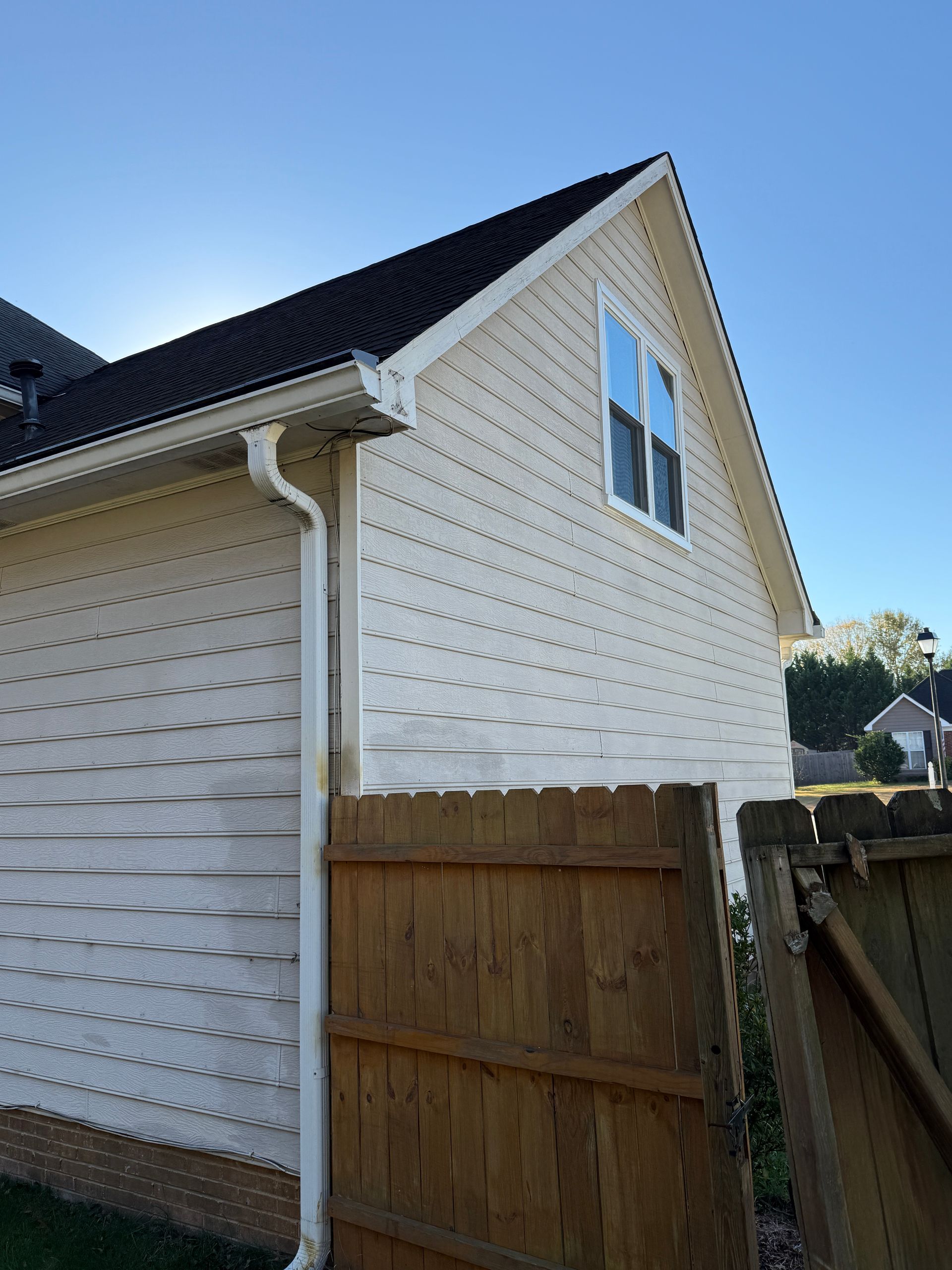 Bathroom with sink, mirror, and light fixture. Cream-colored walls, white vanity, and silver fixtures.