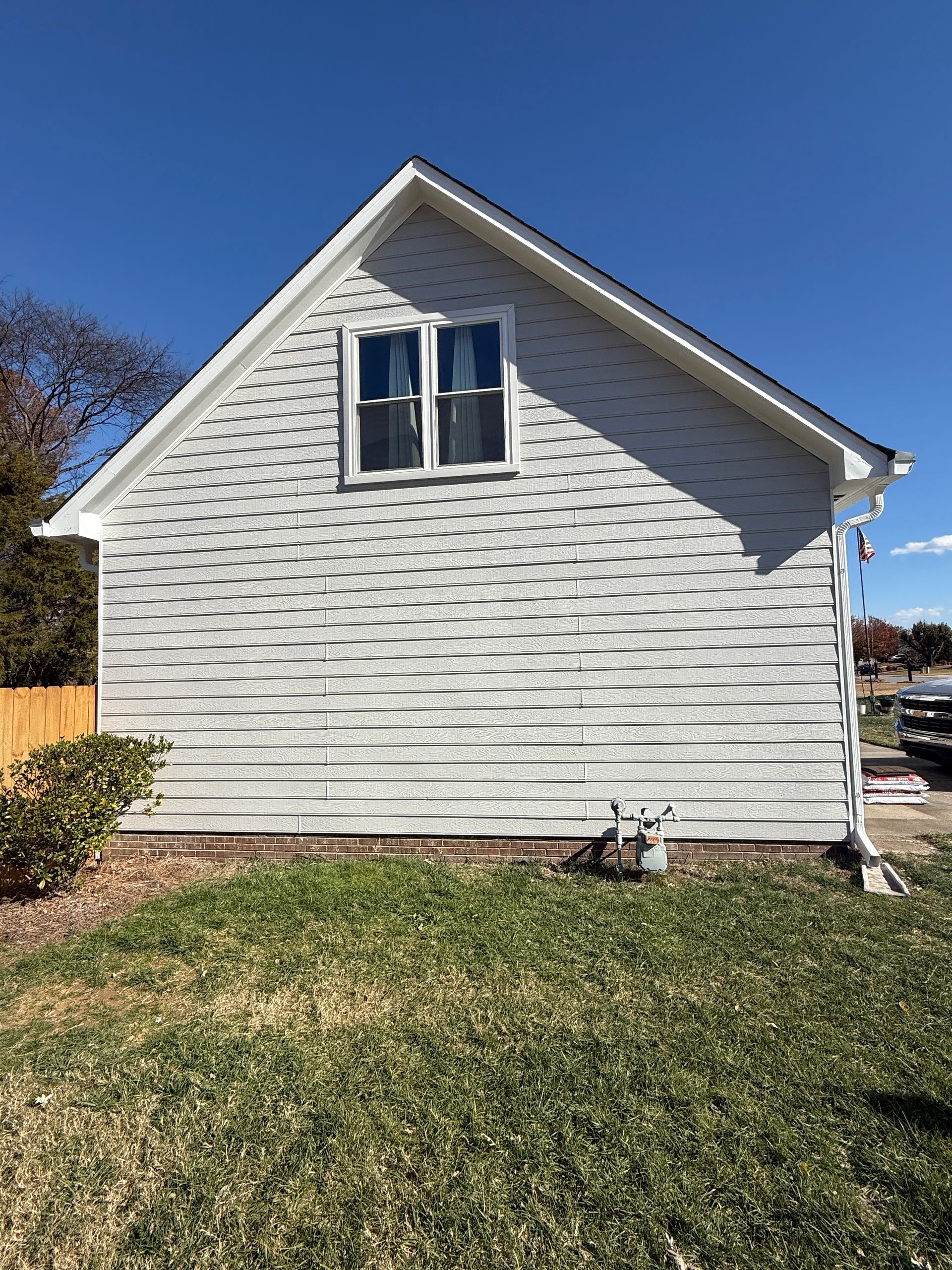 Office with light wood desks, blue chairs, gray filing cabinets, and neutral walls.